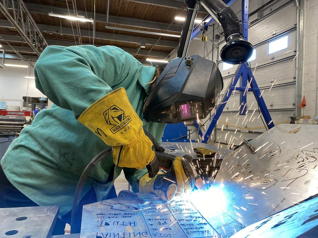 A person welding in the STEAM studio