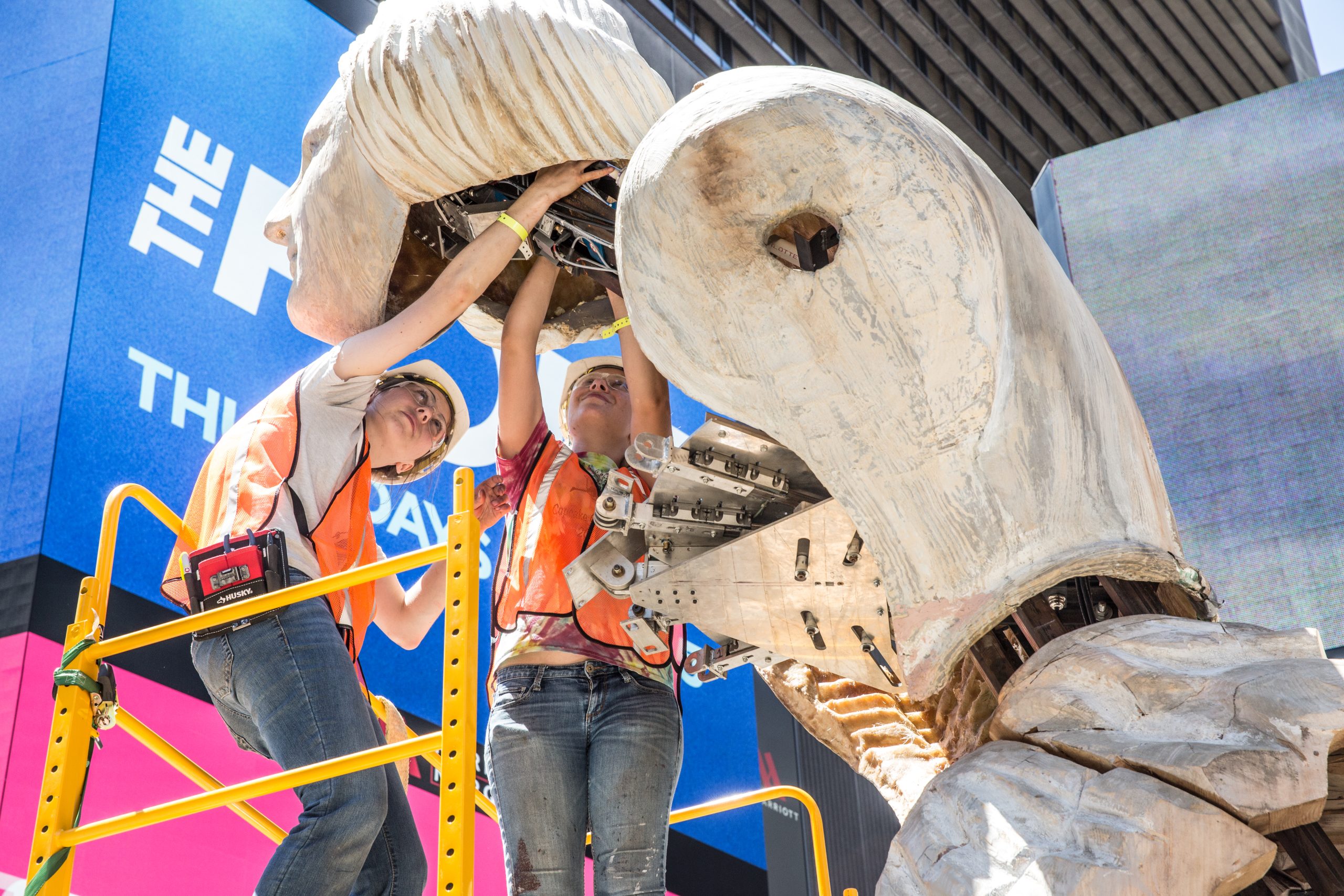 Engineering students assembling a large sculpture in TImes Square