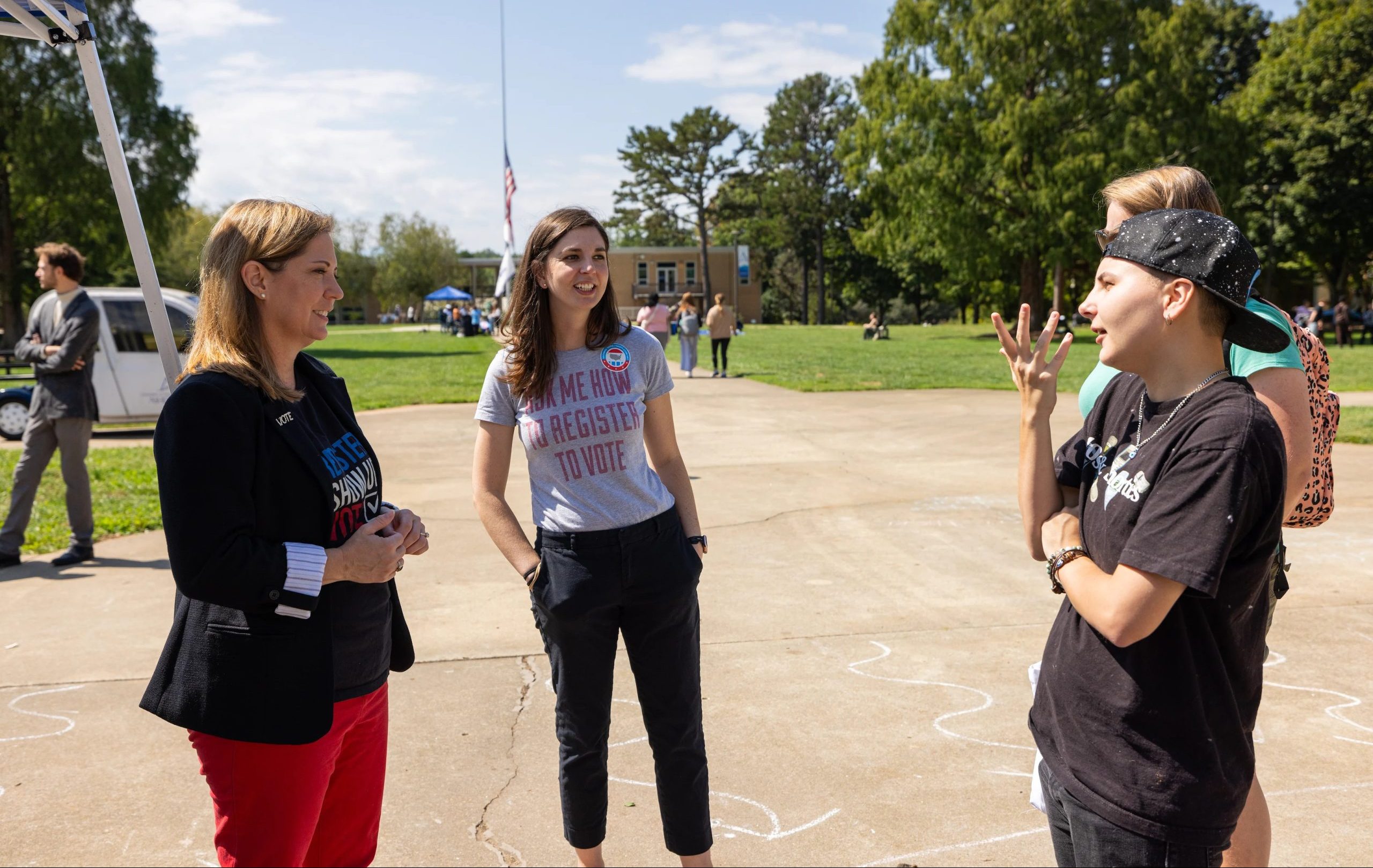 Two students talking to political science alumna Karen Brinson Bell
