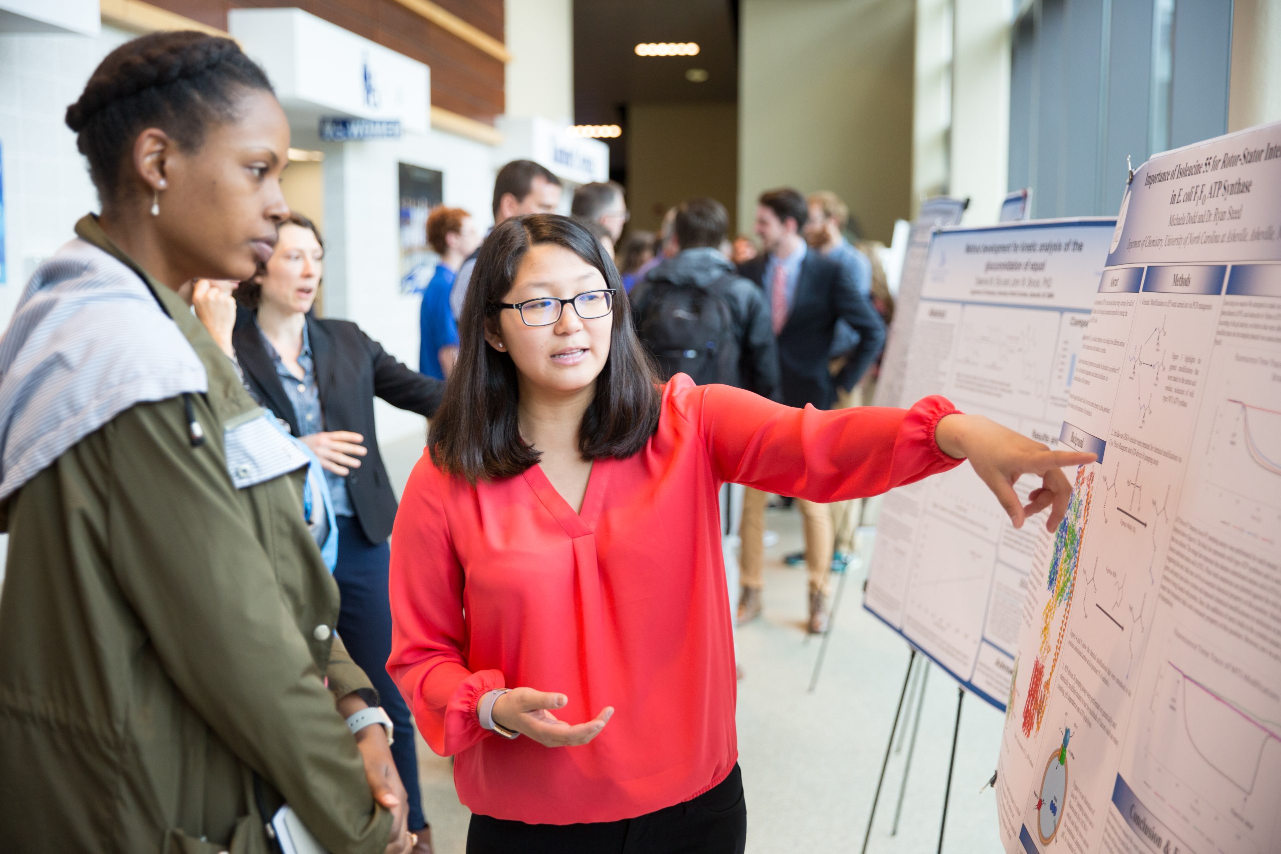 A student showing an undergraduate research project at a symposium