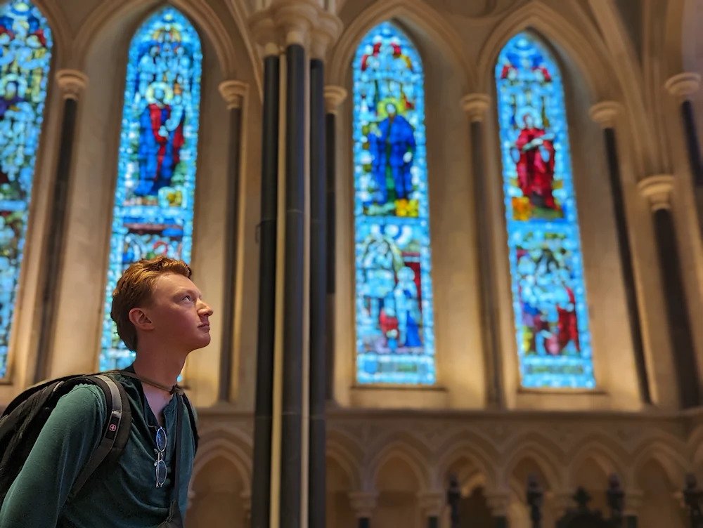 a student looking up in a chapel