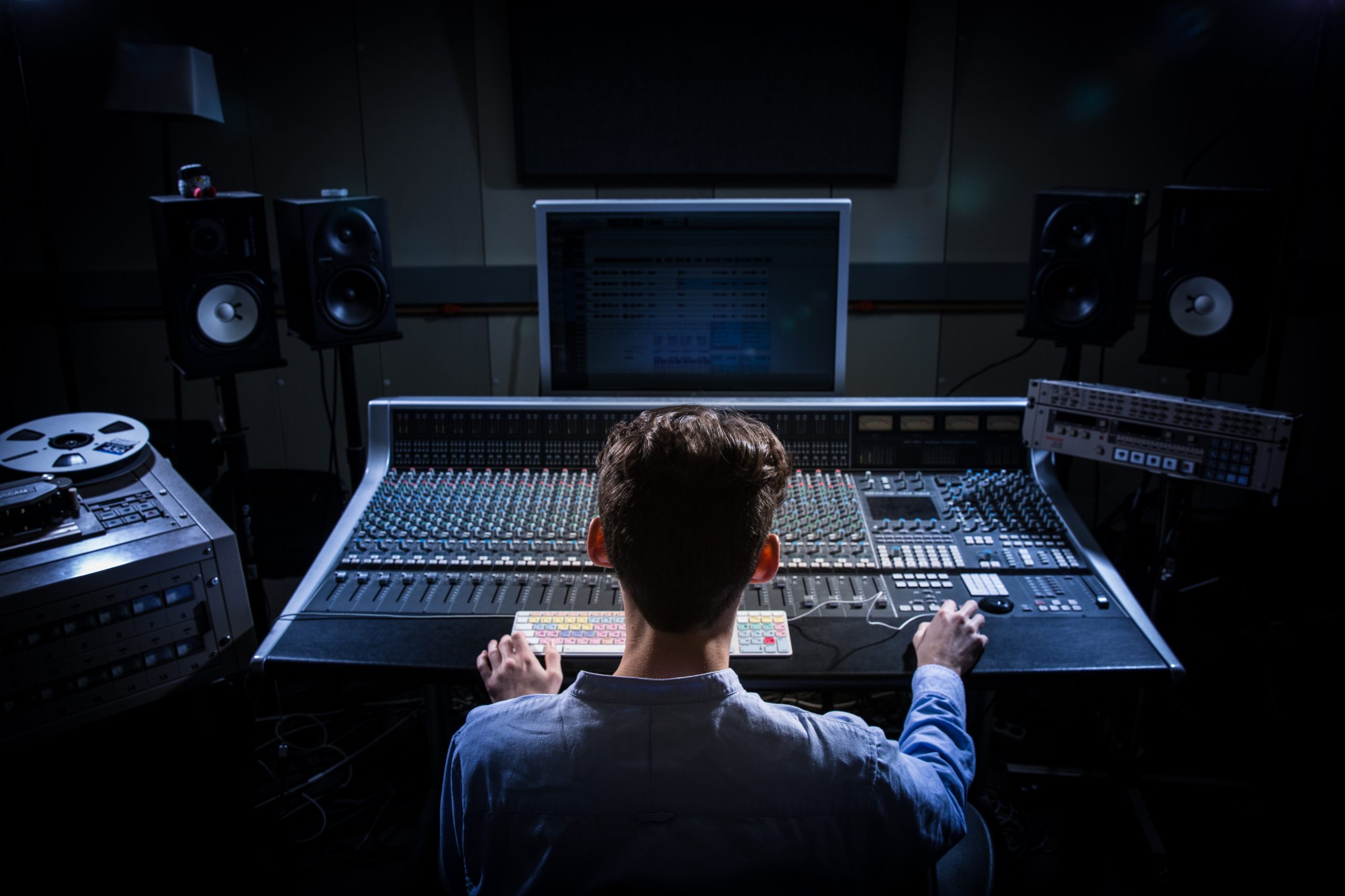 music student using recording equipment in a studio