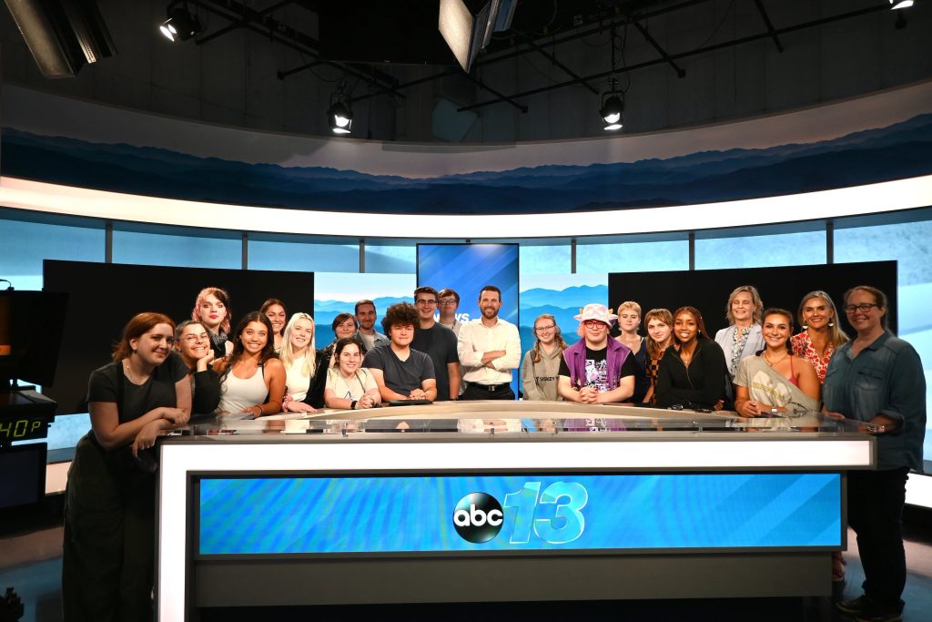 Mass communications students gathered in the WLOS newsroom during a career trek