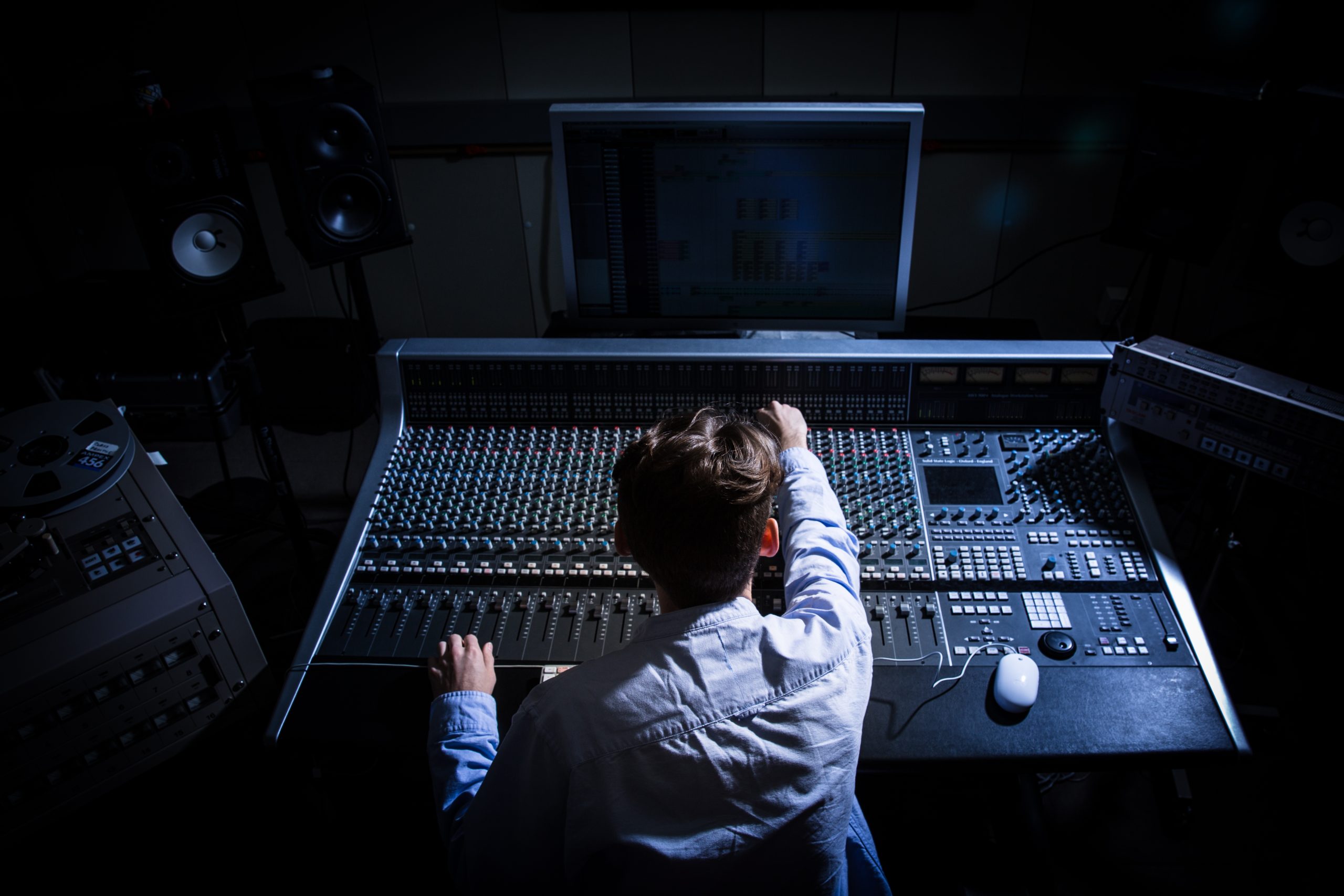 a student using audio equipment in a studio