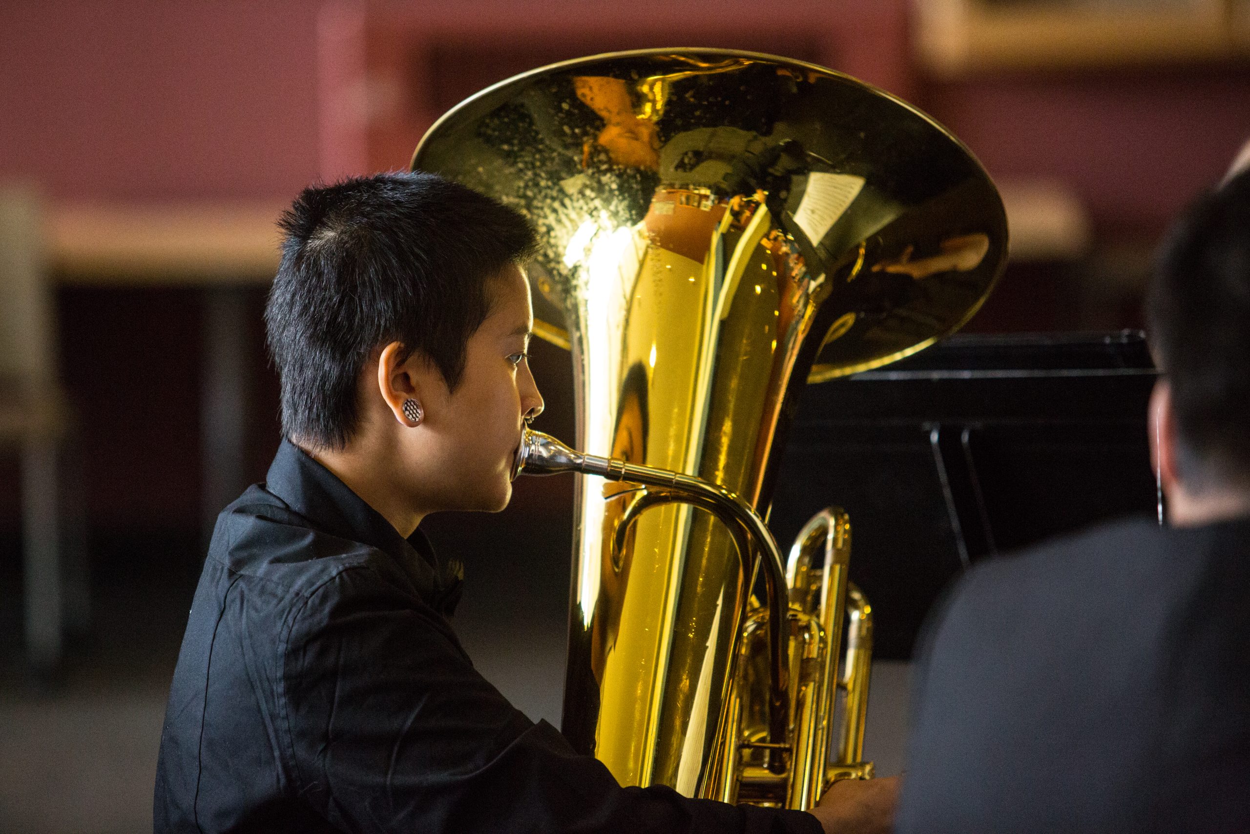 a student playing a tuba