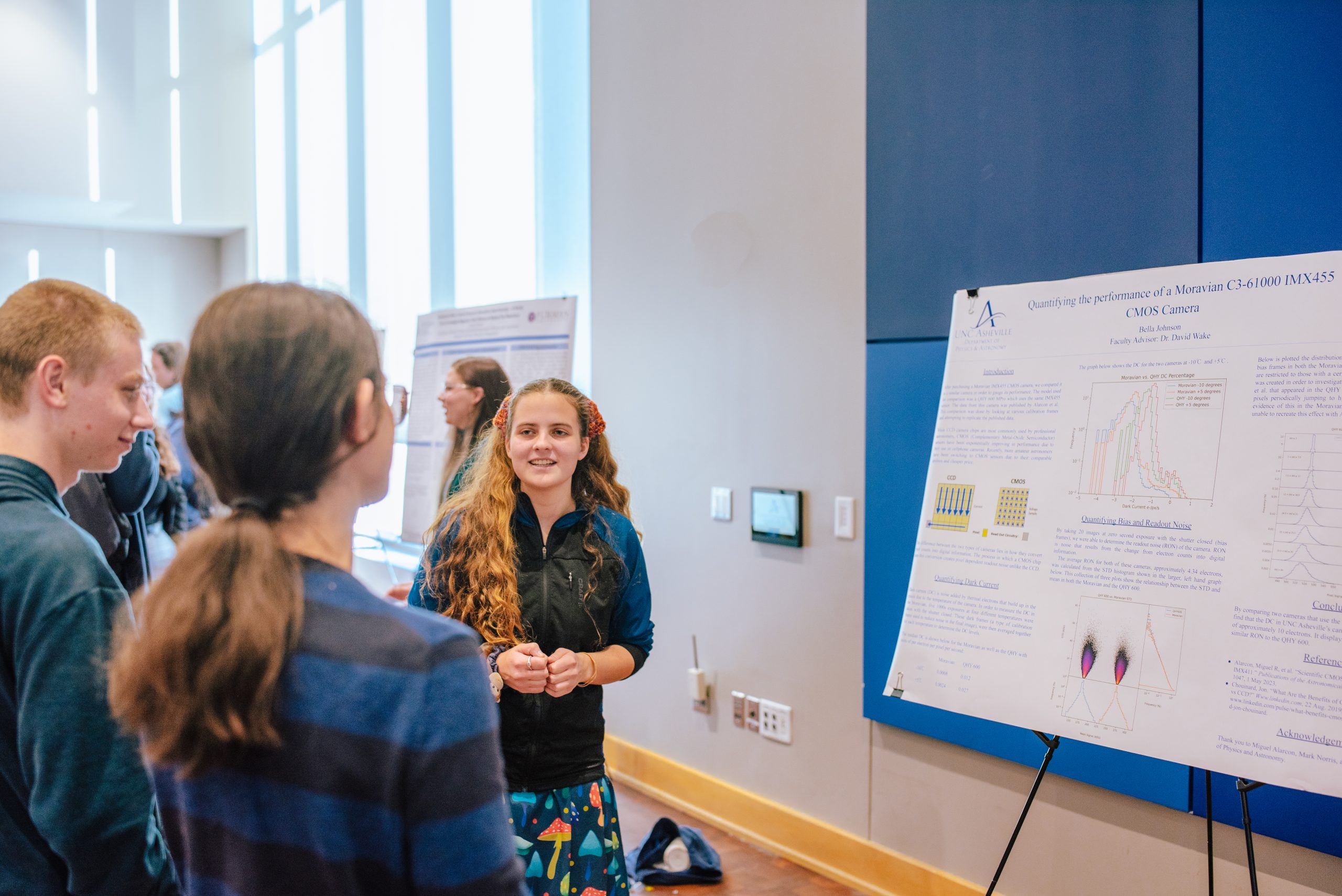 a student presenting an undergraduate research project at a symposium