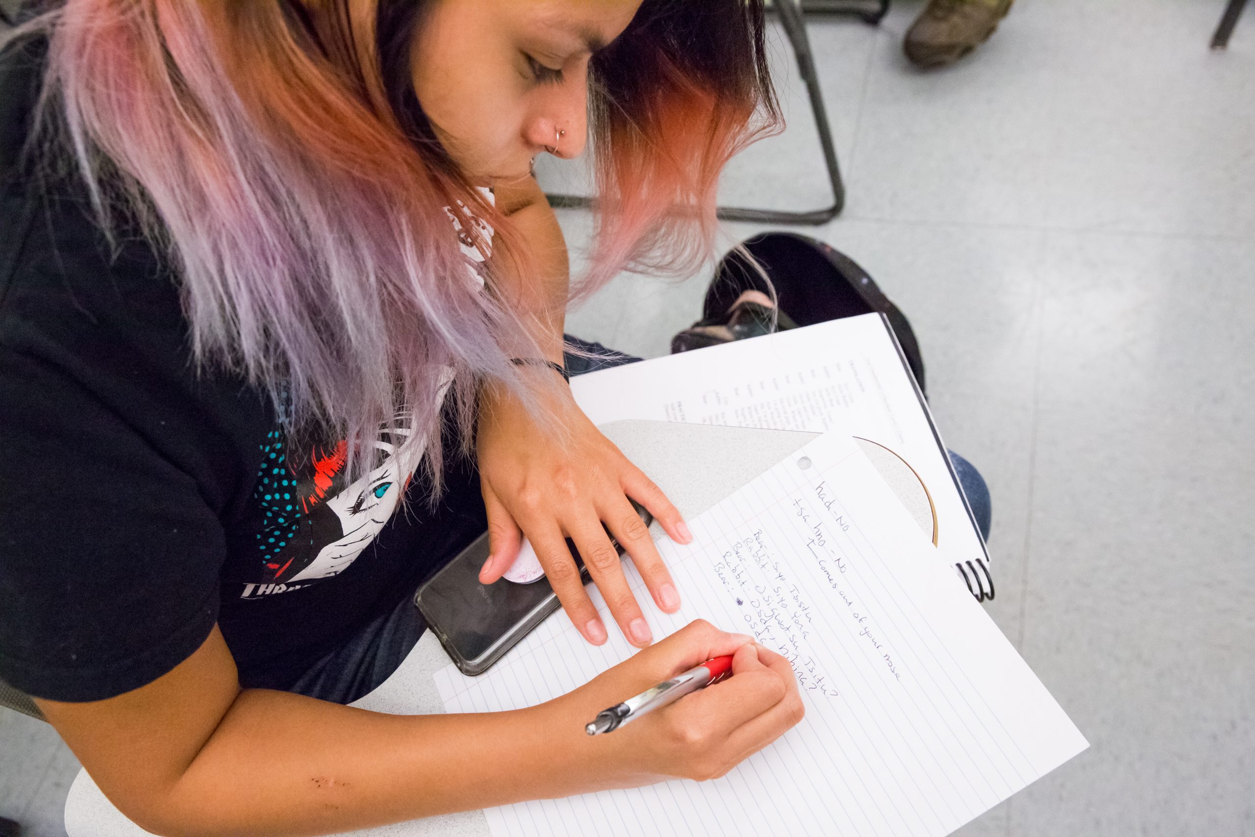 a student writing in a Cherokee language class