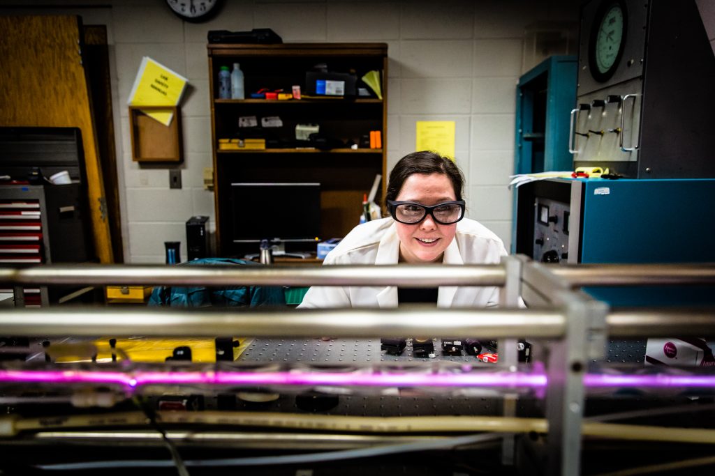 a student in a lab working with lasers