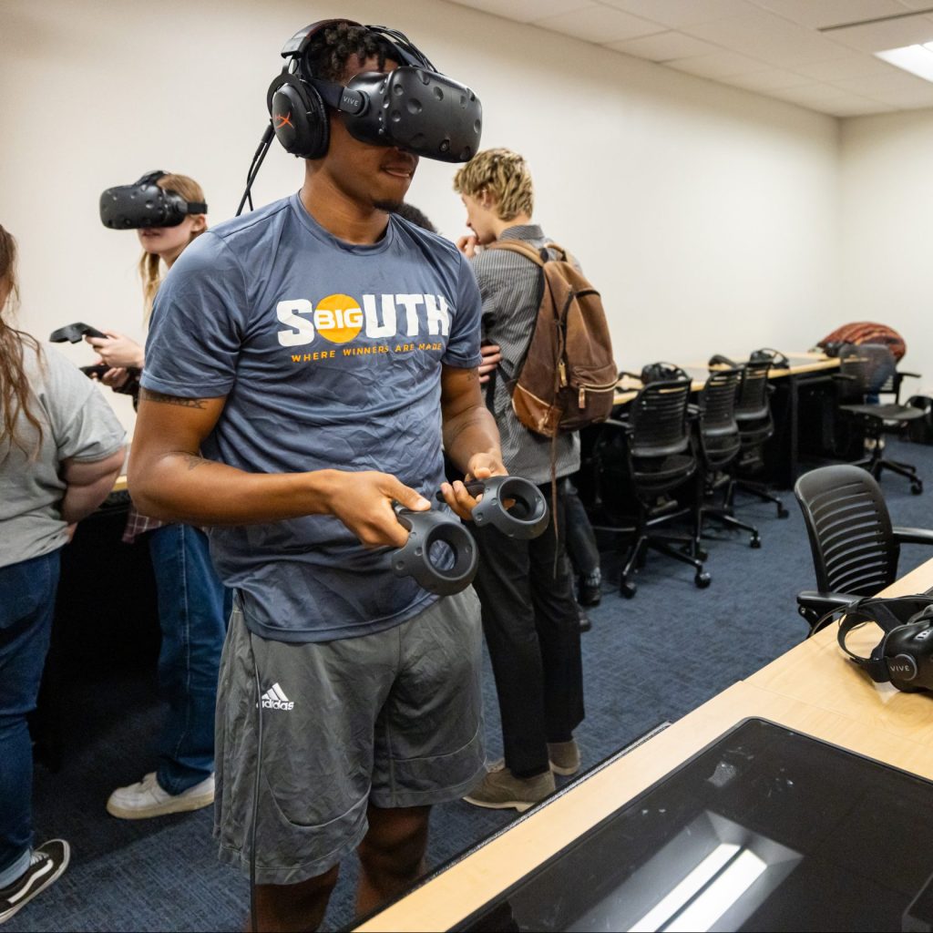 a student using a Virtual reality headset at a VR open house event