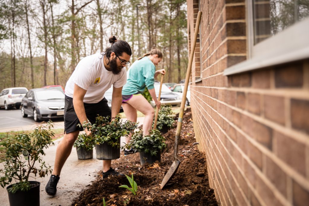 students planting in a garden