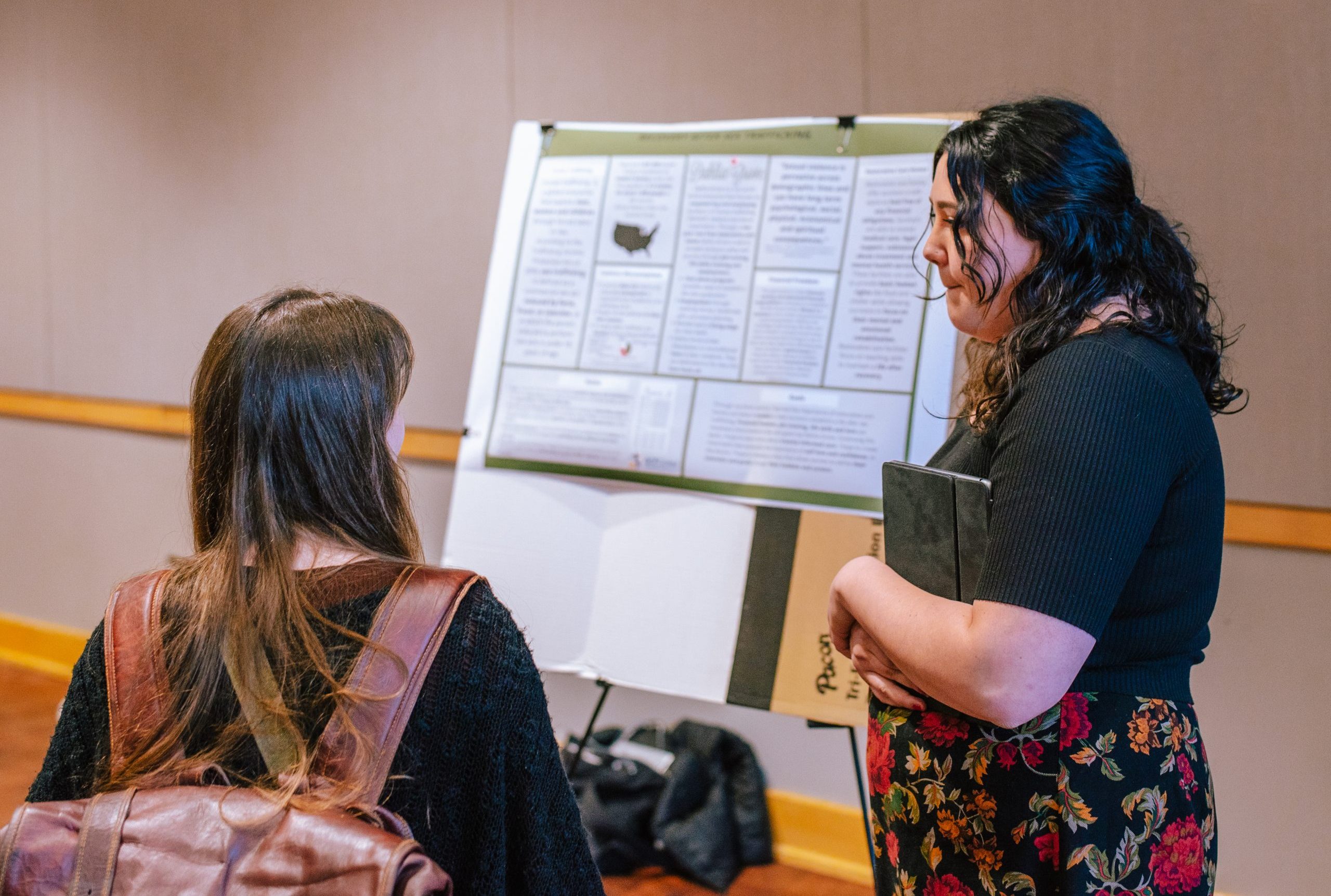 a student presenting a research project at an undergraduate research symposium