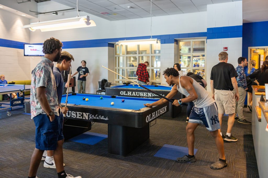 a group of people playing pool in the Highsmith game room