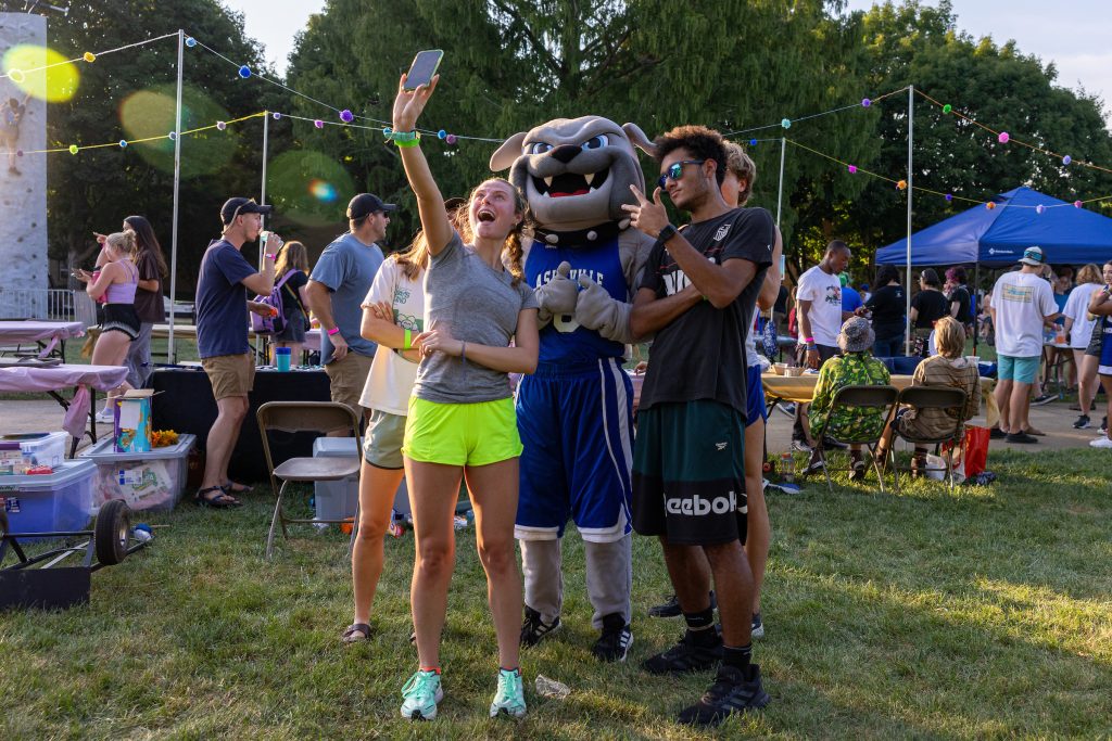 Two students taking a selfie with Rocky