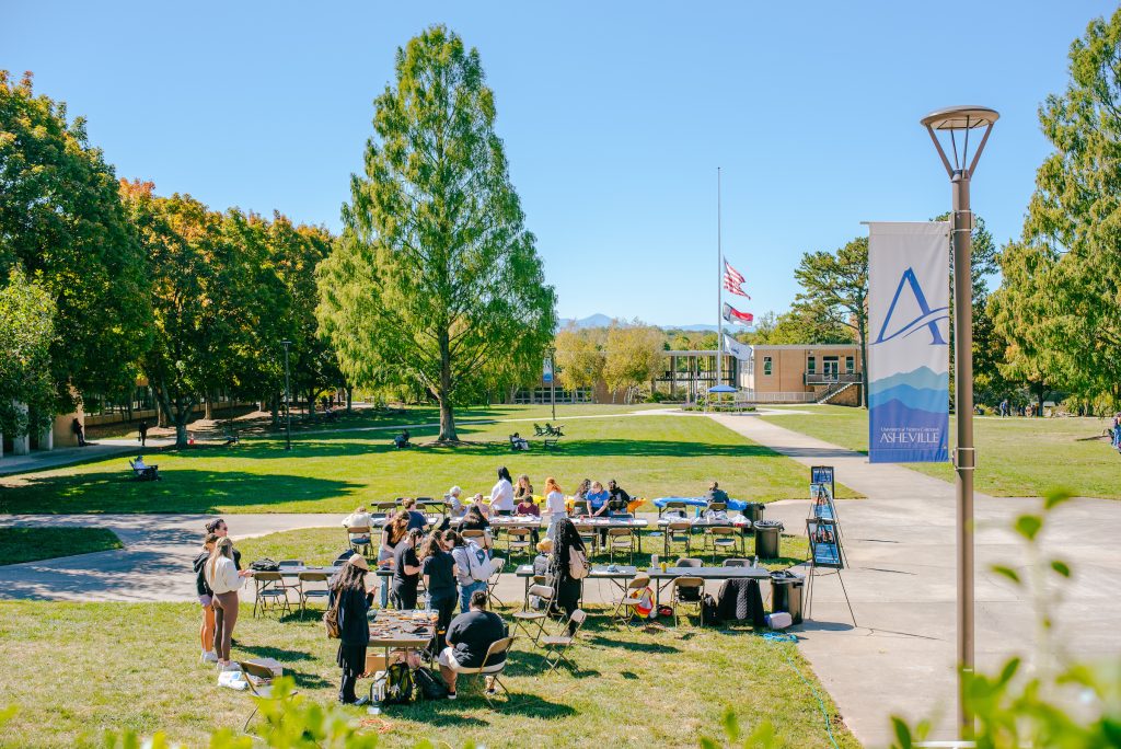 group of students doing a painting activity on the quad