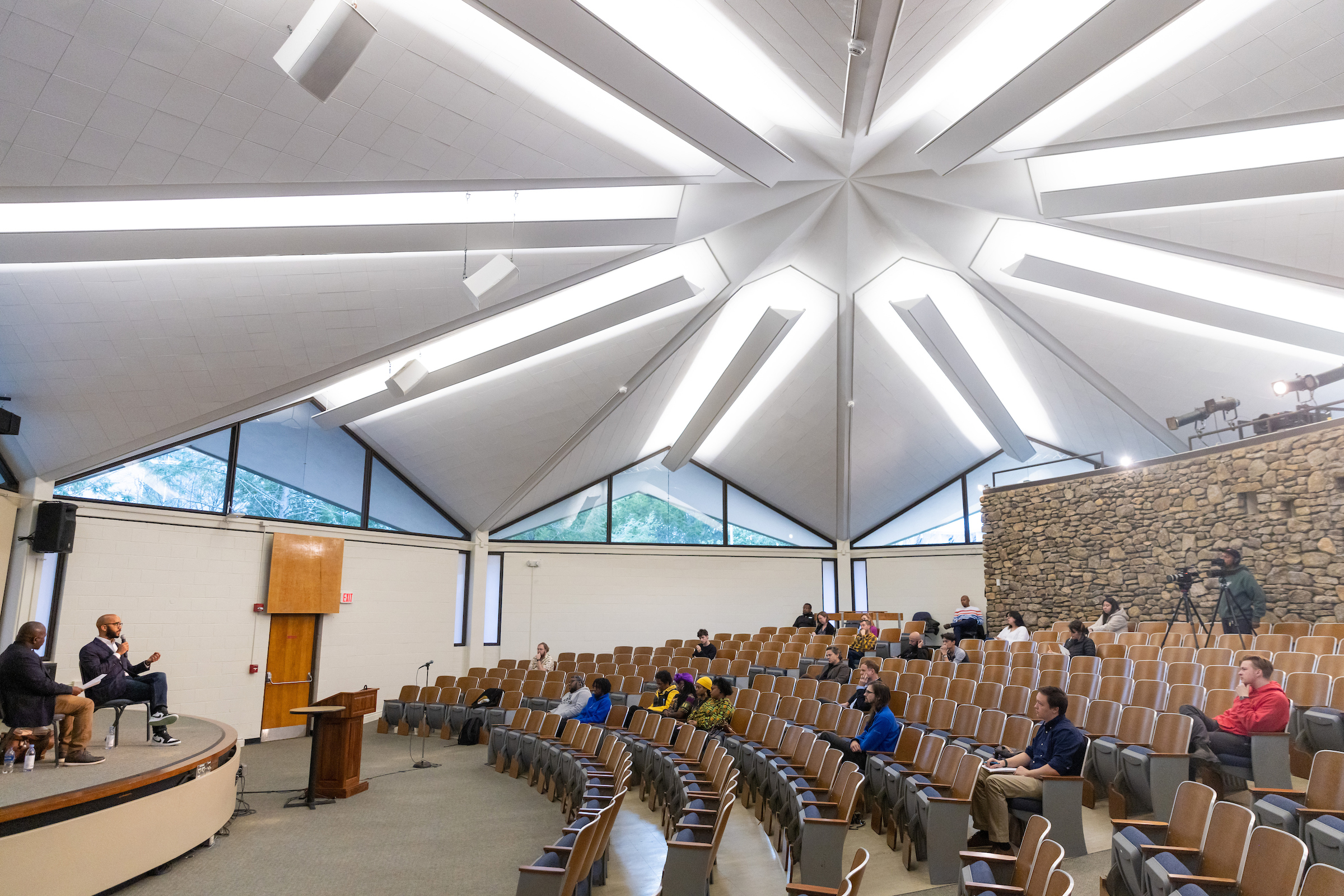 a group of people watching a lecturer in the Mullen Humanities hall