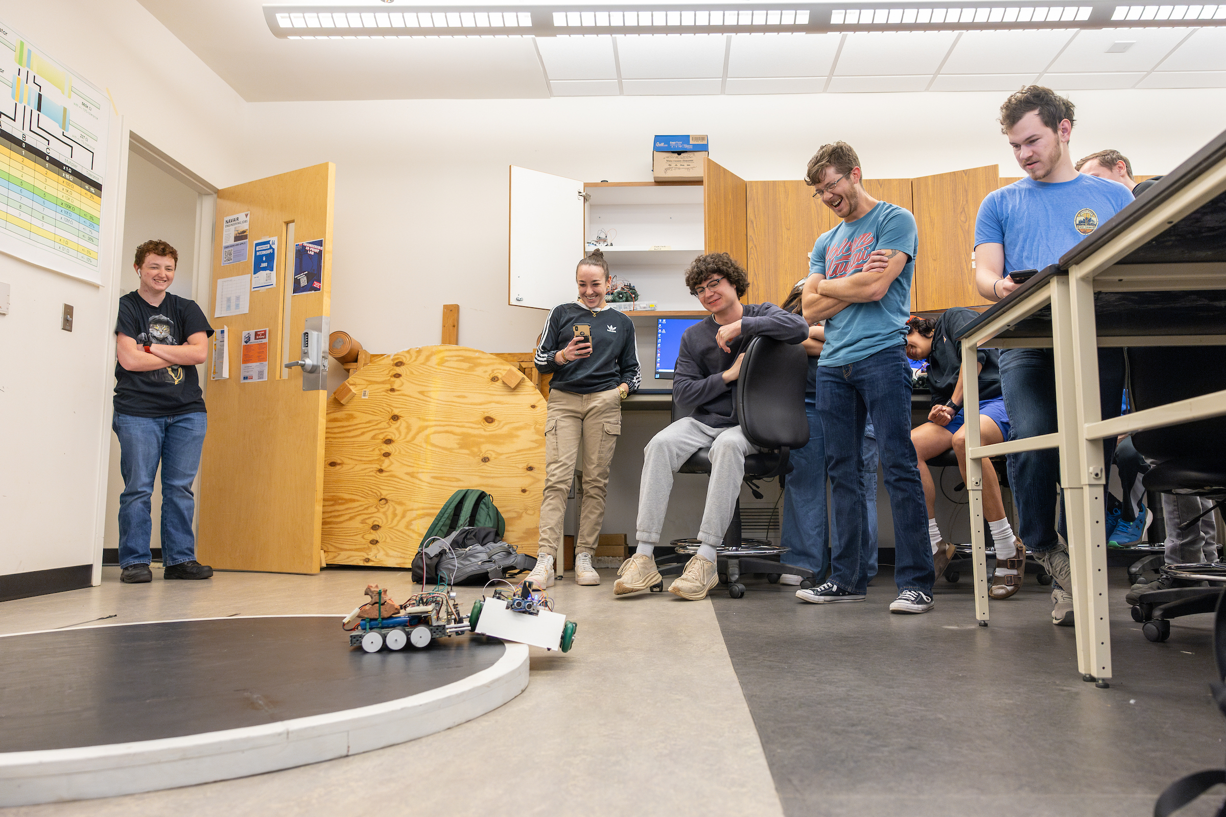 mechatronics students testing 4-wheeled robots