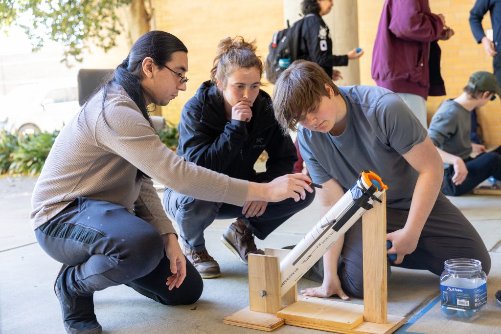 engineering students testing a launcher