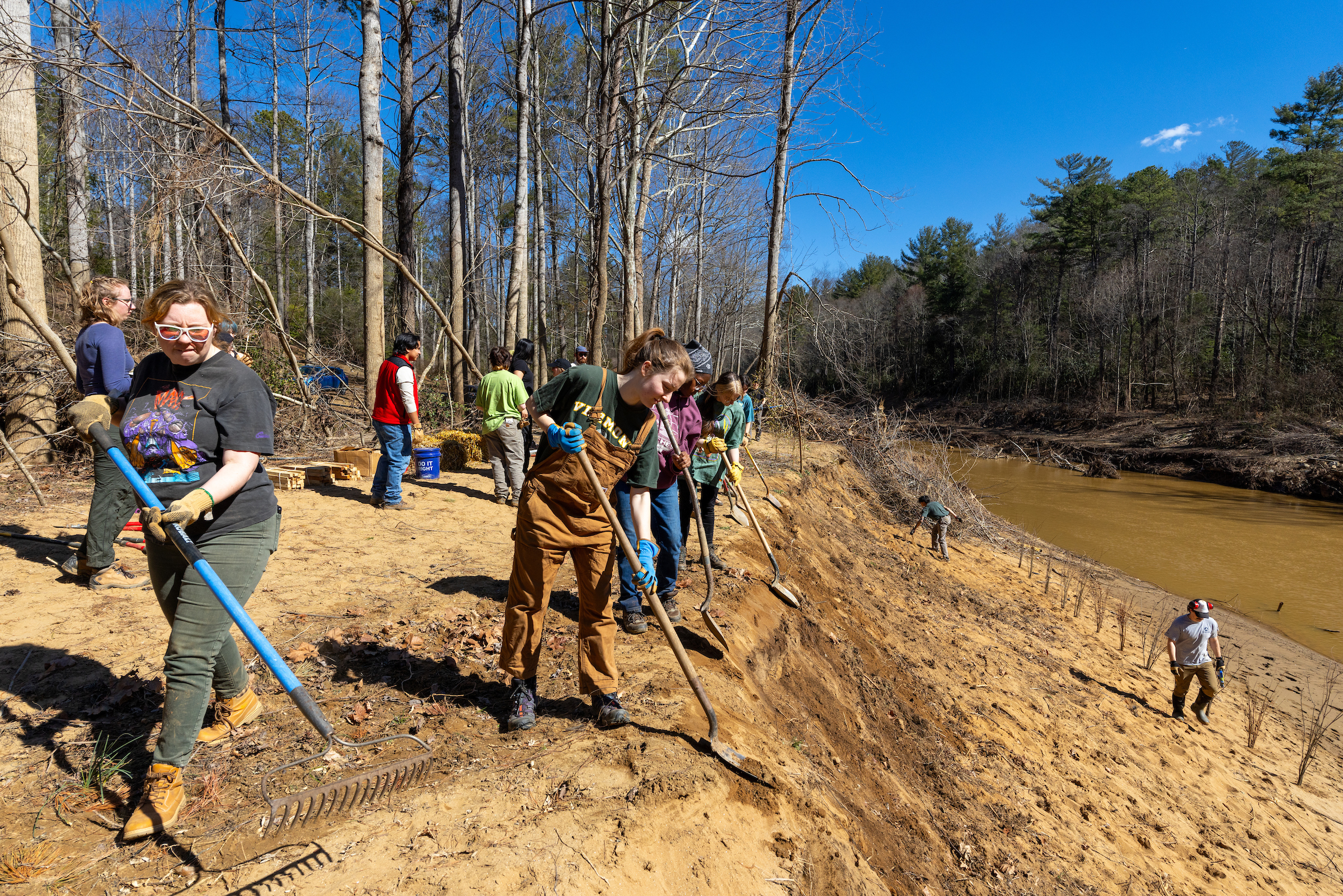 a photo of students repairing the bank of the Swannanoa River.
